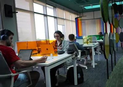 a group of people sitting at tables with laptops at Rivera City, KL Sentral Studio Apartment in Kuala Lumpur