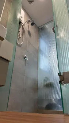 a shower with a glass door in a bathroom at Rivera City, KL Sentral Studio Apartment in Kuala Lumpur