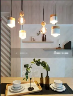 a table with plates and bowls and pendant lights at Arte plus in Ampang