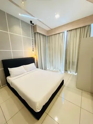 a bedroom with a white bed and a window at Robertson Suites At Bukit Bintang Kuala Lumpur in Kuala Lumpur