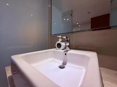 a white sink in a bathroom with a mirror at D'Majestic Place by Roomy in Kuala Lumpur