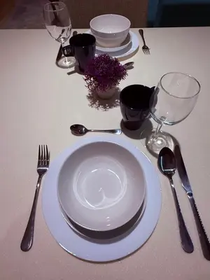 a table with plates and utensils on a table at D'Majestic Place by Roomy in Kuala Lumpur