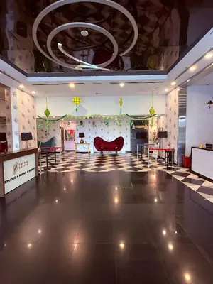a large room with a lobby with a red chair at D'Majestic Place by Roomy in Kuala Lumpur
