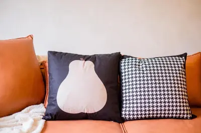 a pillow with a picture of a dress on a couch at Kids Friendly Homestay at Riana Dutamas in Kuala Lumpur
