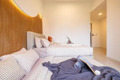 two beds sitting next to each other in a room at Kids Friendly Homestay at Riana Dutamas in Kuala Lumpur