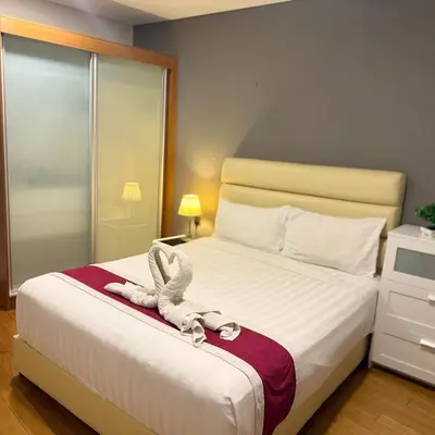 a bedroom with a bed with a stuffed animal on it at Vortex Apartment Near By Klcc in Kuala Lumpur