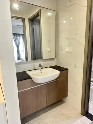 a bathroom with a sink and a mirror at AGILE SKY HOME Near Pavilion with TRX and GOLF View Including Swimming Pool in Kuala Lumpur