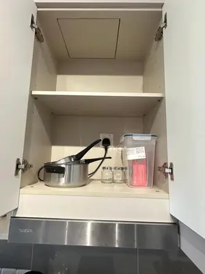 a cabinet with a pot and other items in it at AGILE SKY HOME Near Pavilion with TRX and GOLF View Including Swimming Pool in Kuala Lumpur