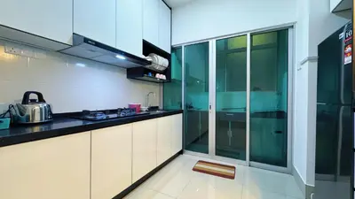 a kitchen with white cabinets and a counter top at Razak City Fully Air-Con Suite Sungai Besi Kuala Lumpur 57100 in Kuala Lumpur