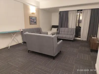 a waiting room with couches and chairs in a hotel room at The Marvelous Suites at Times Square Kuala Lumpur in Kuala Lumpur