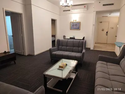 a living room with couches and a table at The Marvelous Suites at Times Square Kuala Lumpur in Kuala Lumpur