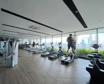 a gym with people exercising on tread machines in a building at The Colony Infinitum By Couple Stay in Kuala Lumpur