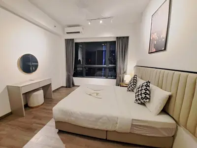 a bedroom with a bed and a desk and a window at Agile marigold Suite KL in Kuala Lumpur