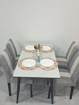 a table with two plates and a vase on it at Agile marigold Suite KL in Kuala Lumpur