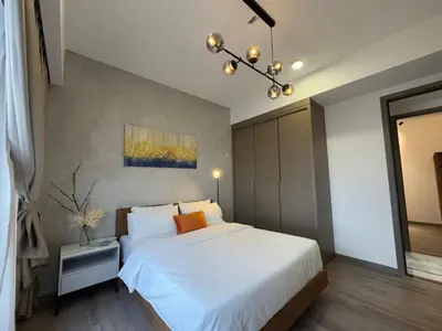 a bedroom with a large white bed and a chandelier at Agile Bukit Bintang TRX KL by Lilbean Space - 2B1R in Kuala Lumpur