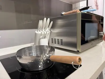 a pot on top of a stove next to a microwave at Agile Bukit Bintang TRX KL by Lilbean Space - 2B1R in Kuala Lumpur