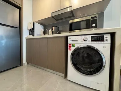 a washing machine in a kitchen with a microwave at Agile Bukit Bintang TRX KL by Lilbean Space - 2B1R in Kuala Lumpur