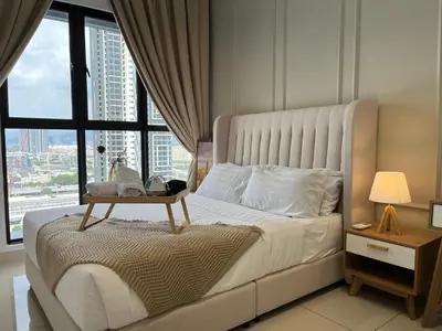 a bedroom with a large bed with a table on it at Trion KL By Couple stay in Kuala Lumpur