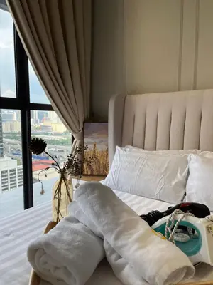 a bedroom with a bed with a large window at Trion KL By Couple stay in Kuala Lumpur