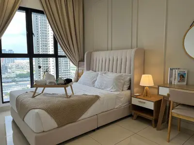 a bedroom with a large bed with a table on it at Trion KL By Couple stay in Kuala Lumpur