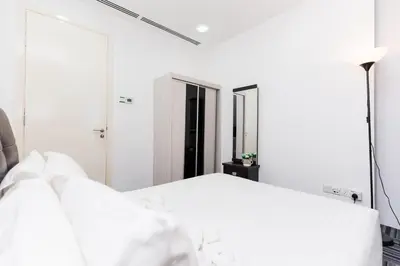 a bedroom with a white bed and a mirror at Binjai 8 Signature by PSM in Kuala Lumpur