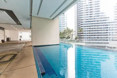 a swimming pool with a view of a building at Binjai 8 Signature by PSM in Kuala Lumpur
