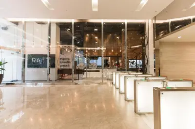 a lobby with tables and chairs in a building at Binjai 8 Signature by PSM in Kuala Lumpur