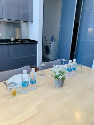 a table with glasses and bottles of water on it at The Mews Glorious Suites KLCC in Kuala Lumpur