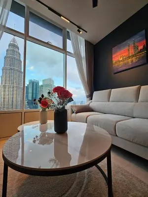 a living room with a coffee table and a couch at Sky suites KLCC Level 58, 600Mbps WiFi - 2R plus 1BB in Kuala Lumpur