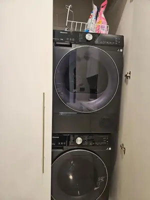 a washer and a washing machine in a room at Sky suites KLCC Level 58, 600Mbps WiFi - 2R plus 1BB in Kuala Lumpur