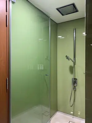 a shower with a glass door in a bathroom at Sky suites KLCC Level 58, 600Mbps WiFi - 2R plus 1BB in Kuala Lumpur