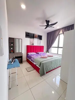 a bedroom with a bed and a dog laying on a table at Cozy 2BR 2BR 2-5 Pax Kenwingston KL Genting View & Parking & Netflix 4505 in Kuala Lumpur
