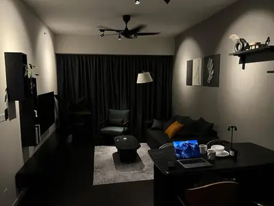 a living room with a couch and a table with a laptop at Luxury Black Suite Agile Bukit Bintang in Kuala Lumpur