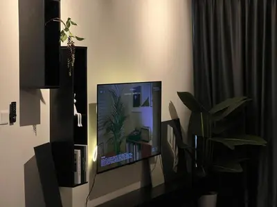 a computer monitor sitting on a desk with a plant at Luxury Black Suite Agile Bukit Bintang in Kuala Lumpur
