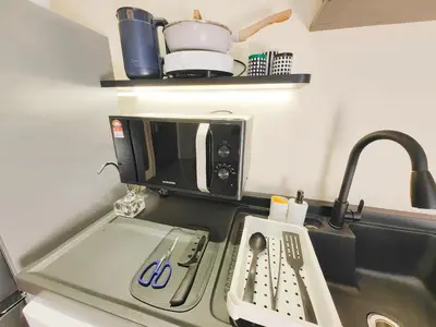 a kitchen counter with a sink and a microwave at The Aspire - Bangsar Trade Centre in Kuala Lumpur