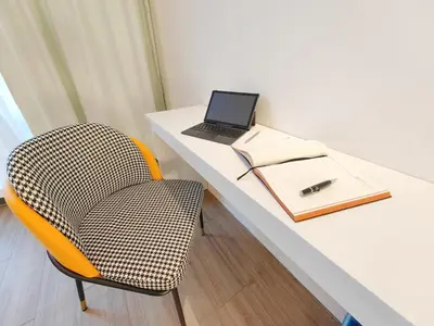 a desk with a chair and a laptop on it at The Aspire - Bangsar Trade Centre in Kuala Lumpur