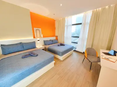a hotel room with two beds and a window at The Aspire - Bangsar Trade Centre in Kuala Lumpur
