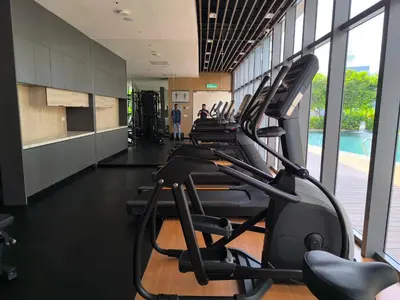 a row of tread machines in a gym at AXON Residence Near TRX & Pavilion KL in Kuala Lumpur