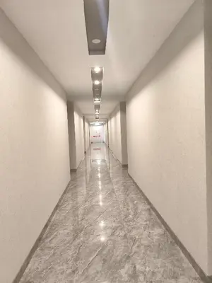an empty hallway with white walls and marble floors at AXON Residence Near TRX & Pavilion KL in Kuala Lumpur