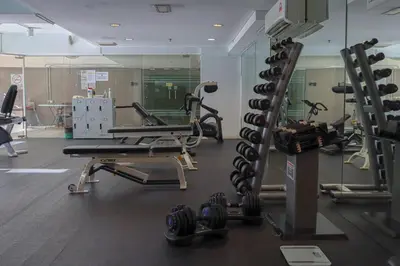 a gym with several tread machines and a mirror at Bintang Goldhill, 5M to TRX in Kuala Lumpur