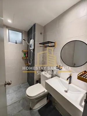 a bathroom with a toilet and a sink and a mirror at Homestay SANGJUTA Setapak - Kid Friendly in Kuala Lumpur