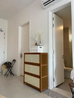 a white room with a cabinet and a bathroom at Cozy Urban Retreat in the Heart of the Bangsar in Kuala Lumpur