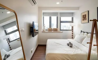 a bedroom with two beds and a mirror at Cozy Studio l Riveria City l 1km to KL Sentral in Kuala Lumpur