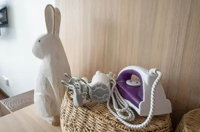a basket with a stuffed rabbit next to a telephone at Cozy Studio l Riveria City l 1km to KL Sentral in Kuala Lumpur