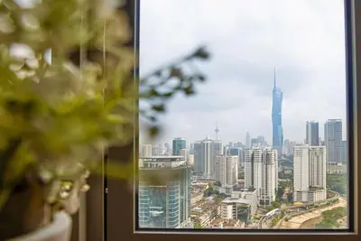 a view of a city skyline from a window at Cozy Studio l Riveria City l 1km to KL Sentral in Kuala Lumpur