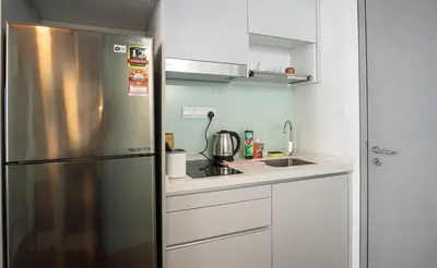 a kitchen with a stainless steel refrigerator and a sink at Cozy Studio l Riveria City l 1km to KL Sentral in Kuala Lumpur