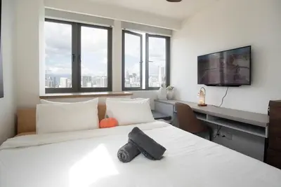 a bedroom with a bed and a desk with a computer at Cozy Studio l Riveria City l 1km to KL Sentral in Kuala Lumpur