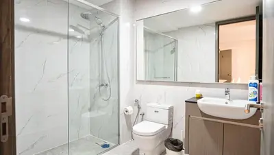 a bathroom with a shower and a toilet and a sink at Cozy Unit l Agile BB l 5min walk to TRX Pavilion in Kuala Lumpur