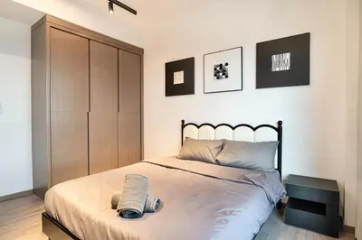 a bedroom with a bed with a wooden cabinet at Cozy Unit l Agile BB l 5min walk to TRX Pavilion in Kuala Lumpur