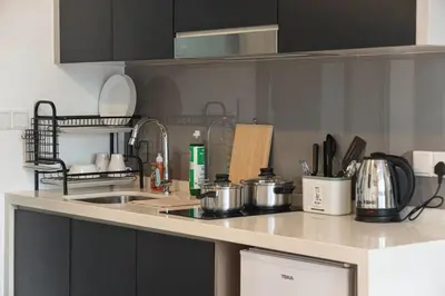 a kitchen with a counter top with pots and pans at Cozy Unit l Agile BB l 5min walk to TRX Pavilion in Kuala Lumpur
